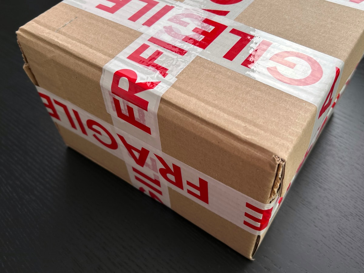 Cardboard parcel sealed with fragile tape